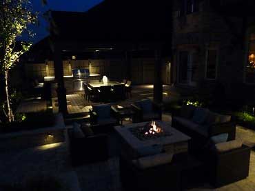 Aerial photo of the patio with landscape lighting on at night