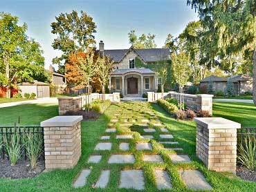 Front entrance with stepping stones in sod and masonry feature wall